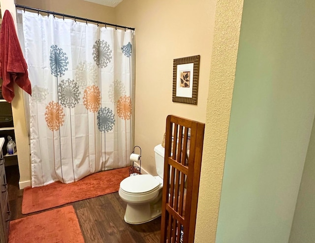 bathroom featuring hardwood / wood-style flooring and toilet