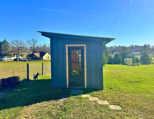 view of outbuilding featuring a lawn