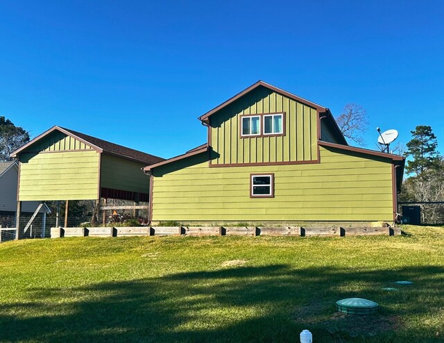 view of side of property featuring a yard and cooling unit