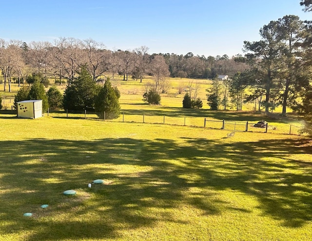 view of community with a lawn and a rural view