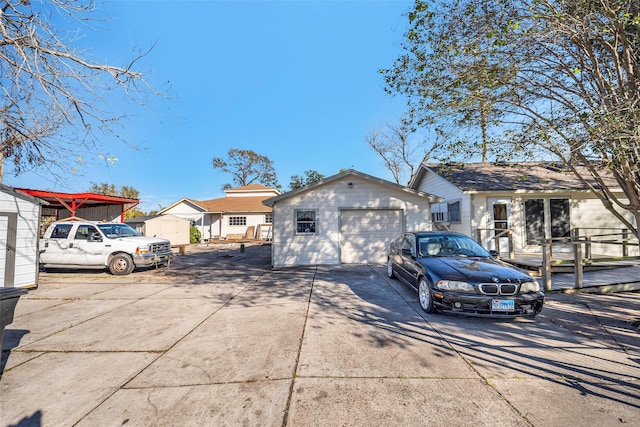 713 Firnat St, Houston, TX 77022 - view of front of home featuring concrete driveway, an outbuilding, and a garage