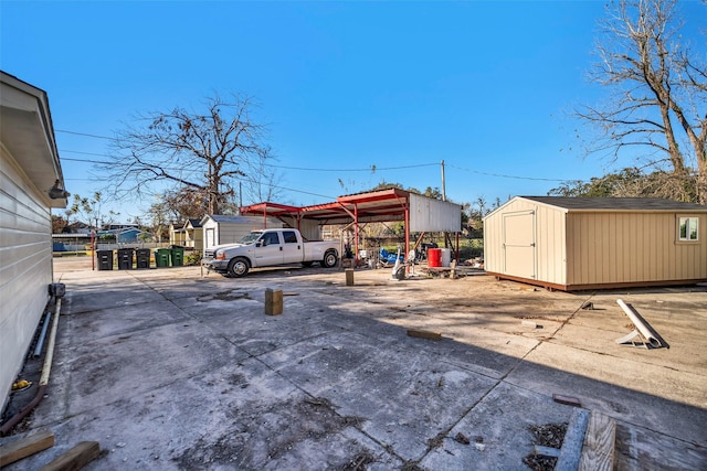 713 Firnat St, Houston, TX 77022 - view of parking / parking lot with a storage unit and a detached carport