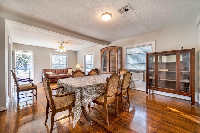 dining room with a wealth of natural light, dark hardwood / wood-style flooring, and ceiling fan