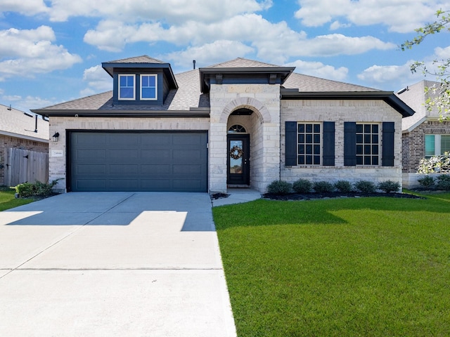 view of front of property with a front yard and a garage