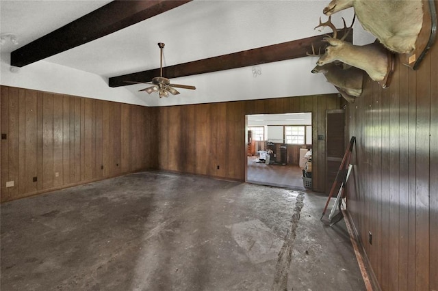 unfurnished room featuring ceiling fan, wood walls, and lofted ceiling with beams