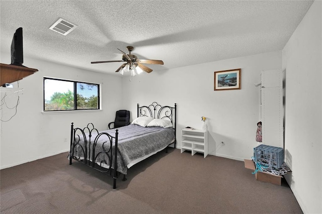 carpeted bedroom featuring a textured ceiling and ceiling fan