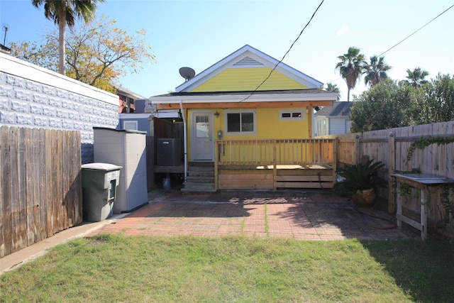 back of house featuring a patio area and a yard