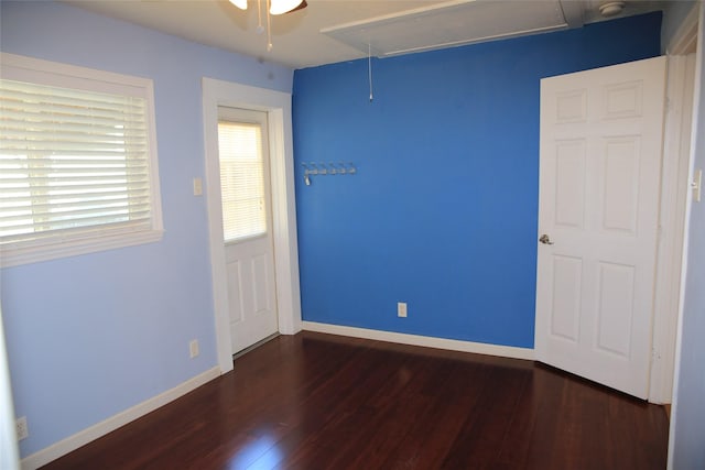 unfurnished room with ceiling fan and dark hardwood / wood-style flooring