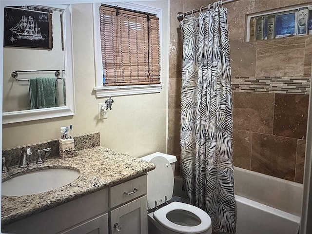 full bathroom featuring shower / tub combo with curtain, vanity, and toilet