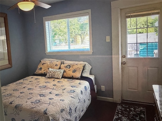 bedroom with multiple windows and ceiling fan