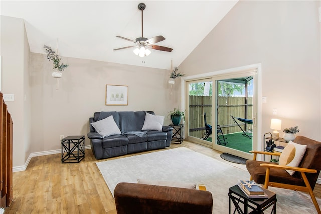 living room featuring ceiling fan, high vaulted ceiling, and light hardwood / wood-style flooring