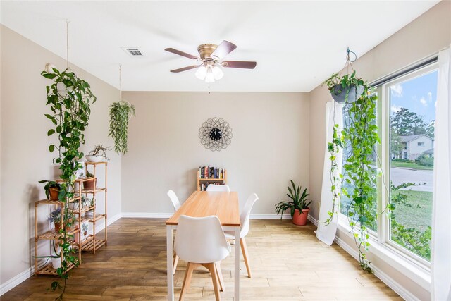 dining area featuring hardwood / wood-style flooring and ceiling fan