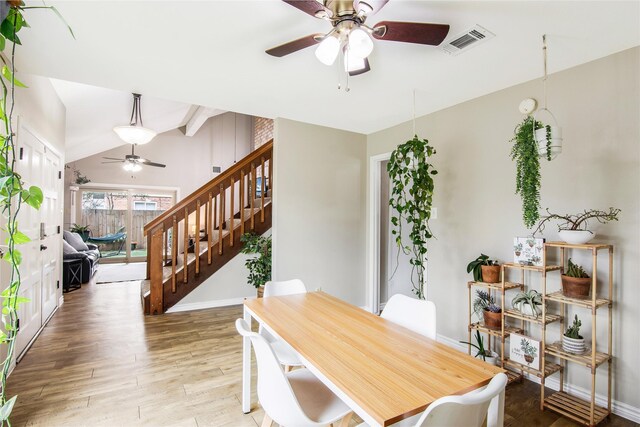 dining area featuring vaulted ceiling with beams, ceiling fan, and hardwood / wood-style flooring