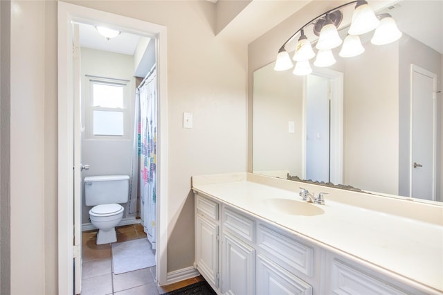 bathroom with tile patterned floors, vanity, and toilet