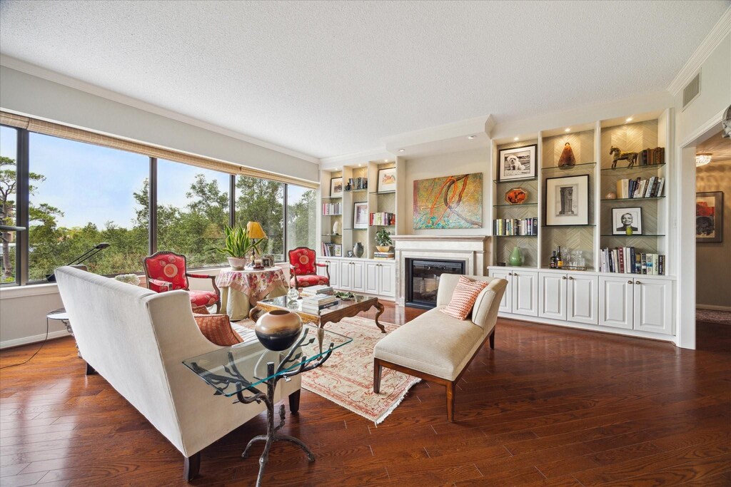 101 Westcott St Unit 404, Houston, TX 77007 - living room featuring a textured ceiling, dark hardwood / wood-style flooring, and built in features