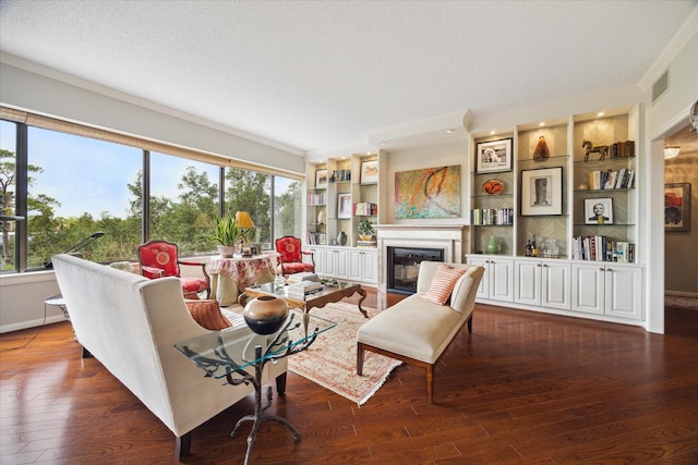 living room featuring a textured ceiling, dark hardwood / wood-style flooring, and built in features