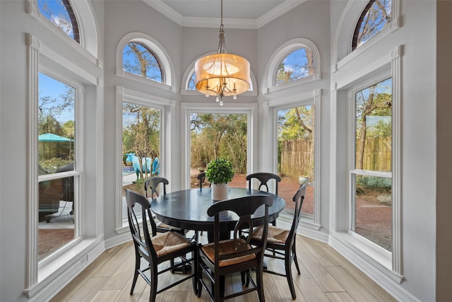 sunroom / solarium featuring a notable chandelier and a wealth of natural light