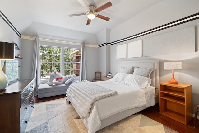 bedroom featuring ceiling fan, lofted ceiling, and light hardwood / wood-style flooring