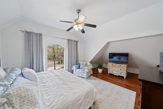 bedroom with ceiling fan, dark hardwood / wood-style floors, and vaulted ceiling