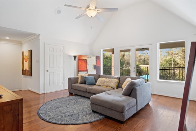 living room featuring hardwood / wood-style flooring, high vaulted ceiling, french doors, and a healthy amount of sunlight