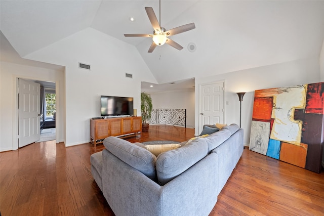 living room featuring hardwood / wood-style flooring, ceiling fan, and high vaulted ceiling