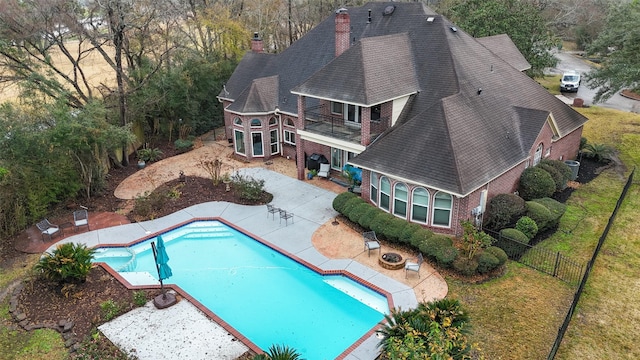 view of pool with a patio and an outdoor fire pit