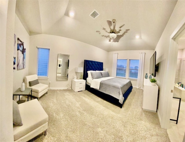 bedroom featuring light colored carpet, vaulted ceiling, and ceiling fan