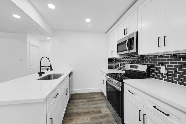 kitchen featuring kitchen peninsula, white cabinetry, sink, and stainless steel appliances