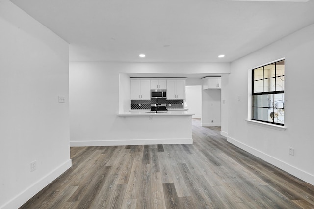 unfurnished living room featuring hardwood / wood-style floors