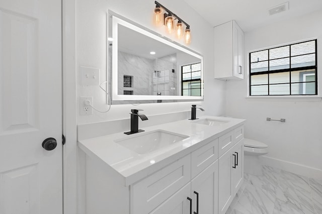 bathroom featuring vanity, an enclosed shower, and toilet