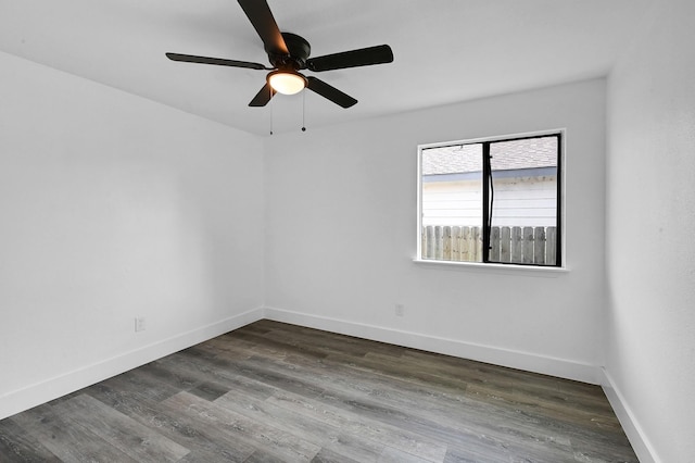 empty room featuring ceiling fan and dark hardwood / wood-style flooring