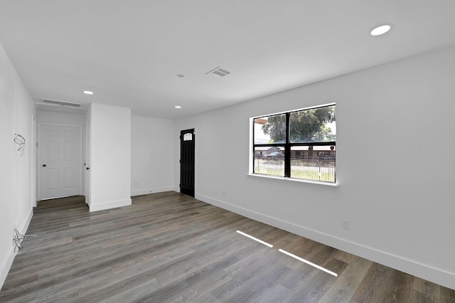 empty room with hardwood / wood-style flooring