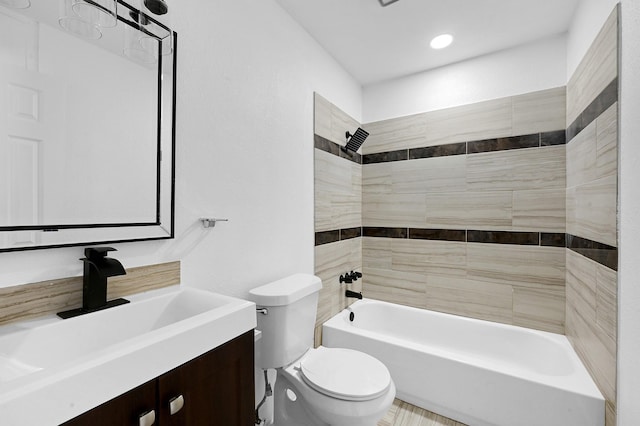 full bathroom with tiled shower / bath, vanity, and toilet