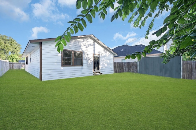 rear view of property featuring a yard