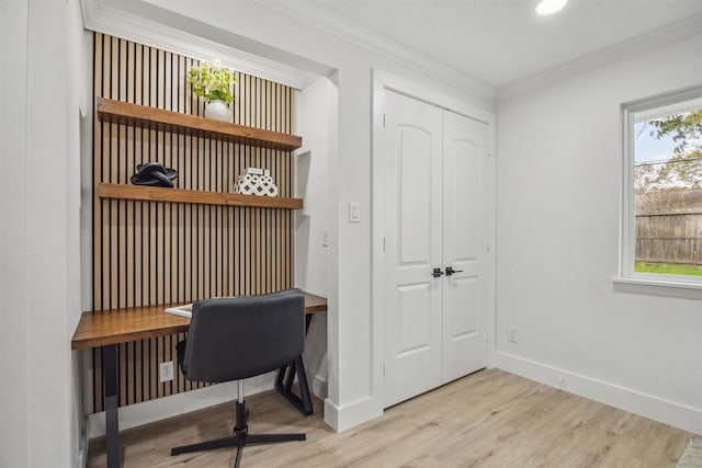 office area with light hardwood / wood-style flooring and ornamental molding