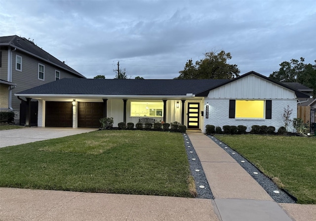 view of front of house featuring a garage and a front lawn