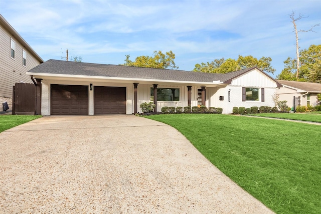 view of front facade with a garage and a front lawn