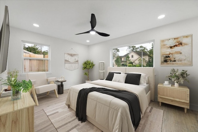 bedroom with ceiling fan and light wood-type flooring