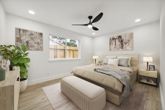 bedroom with light hardwood / wood-style floors and ceiling fan