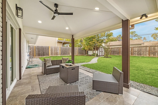 view of patio / terrace with an outdoor living space and a storage shed