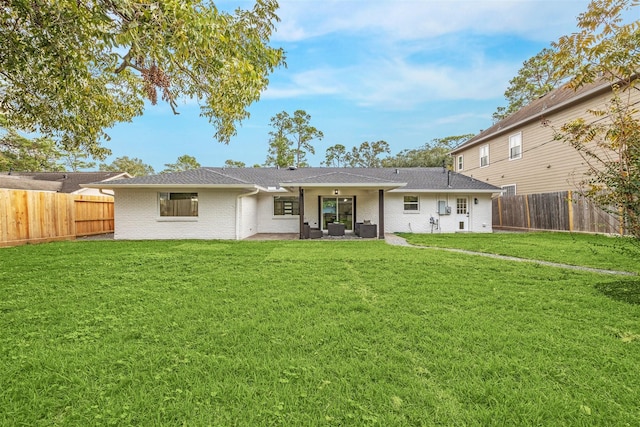 back of property featuring outdoor lounge area, a yard, and central air condition unit