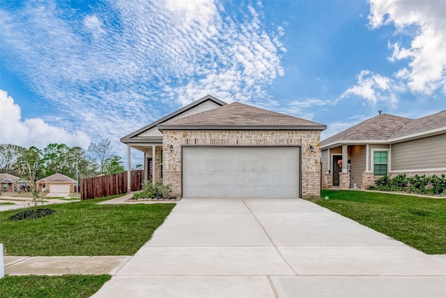 view of front of property featuring a garage, concrete driveway, fence, and a front lawn