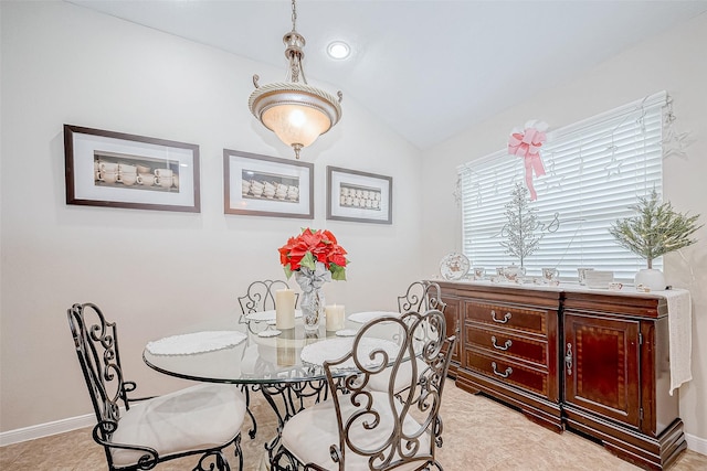 dining room featuring vaulted ceiling