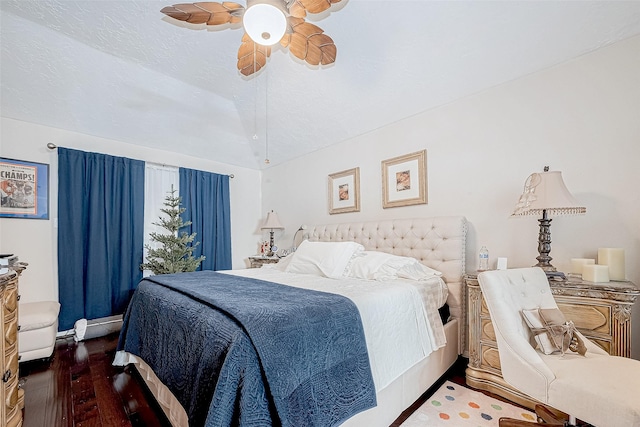 bedroom with a textured ceiling, dark hardwood / wood-style floors, and ceiling fan