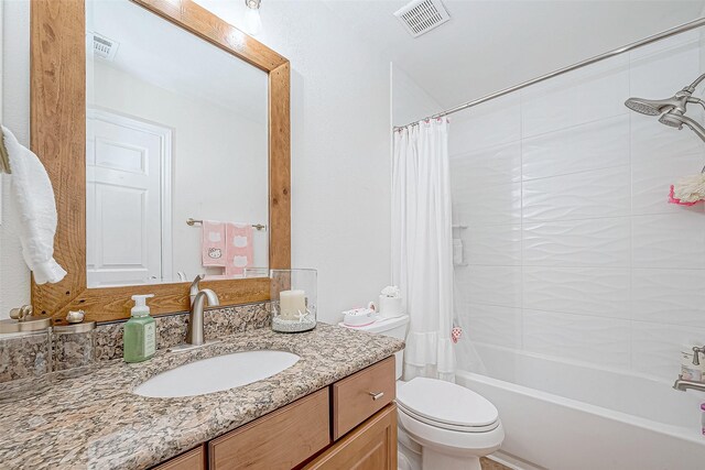 full bathroom featuring vanity, toilet, and shower / bath combo with shower curtain