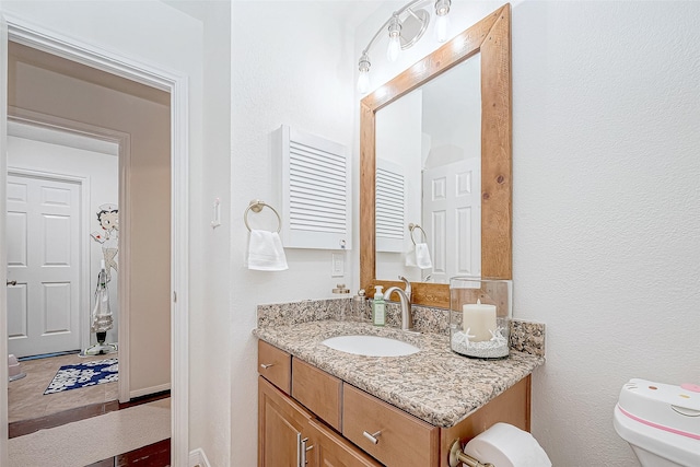 bathroom featuring vanity and toilet