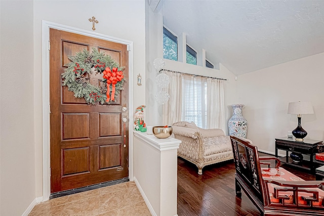 foyer entrance featuring light hardwood / wood-style flooring and lofted ceiling