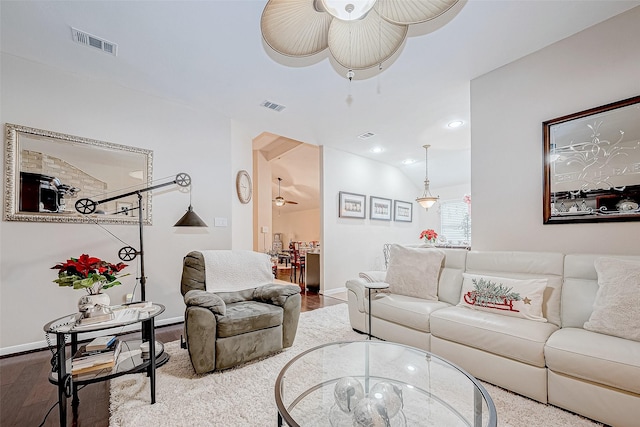 living room with wood-type flooring, vaulted ceiling, and ceiling fan