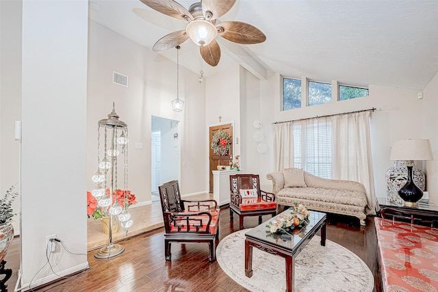 living room with hardwood / wood-style floors, high vaulted ceiling, and beamed ceiling