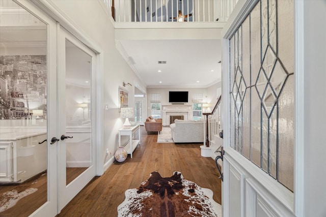 entryway with french doors, ornamental molding, and hardwood / wood-style flooring